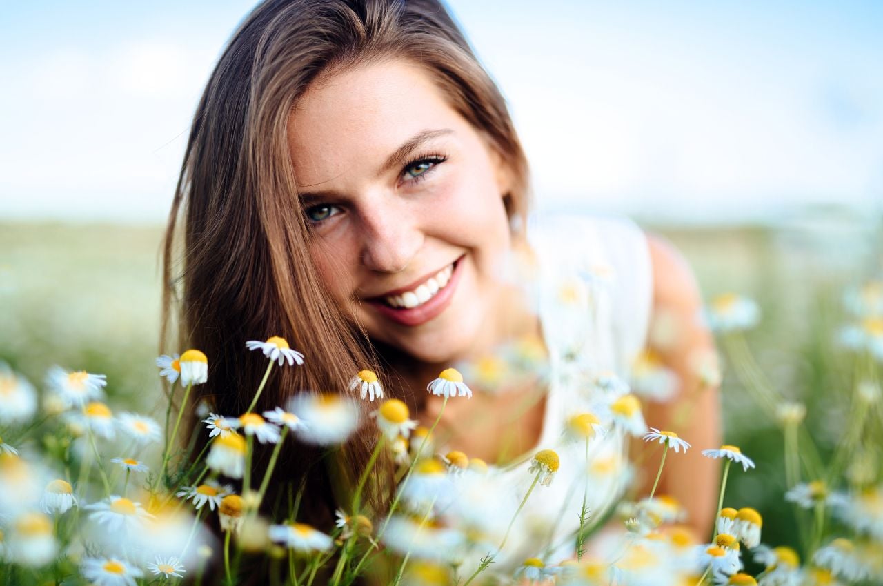 woman in chamomile field