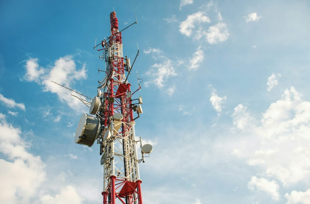 Low angle view of Antenna tower against a blue sky. 5g network cell tower. Geoengineering