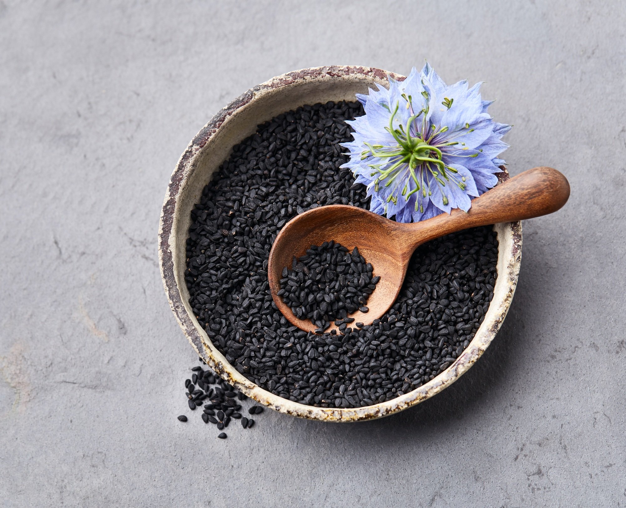 Black cumin seeds on graphite background